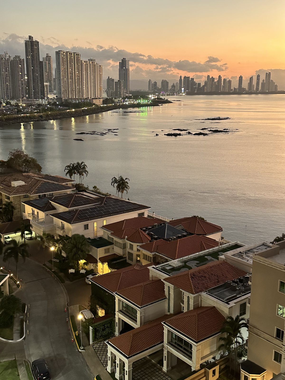 Panama City skyline and tiled-roof homes at sunset